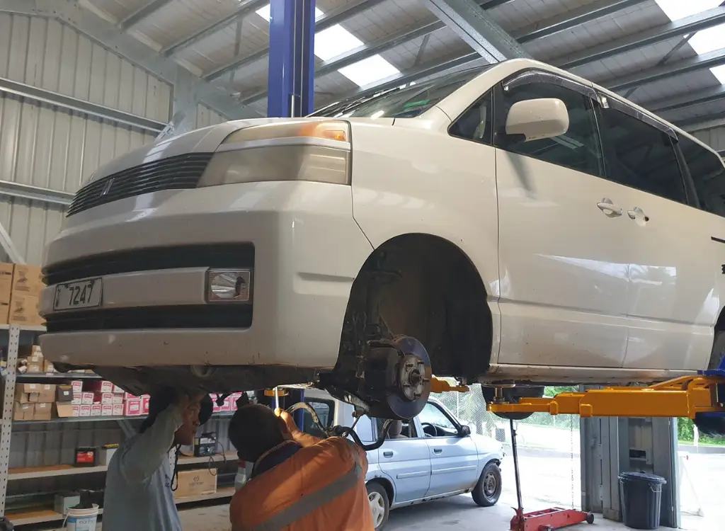 Vehicle being serviced on a hoist